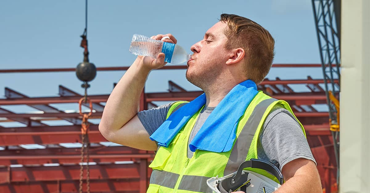 Construction worker drinking water in the hot weather